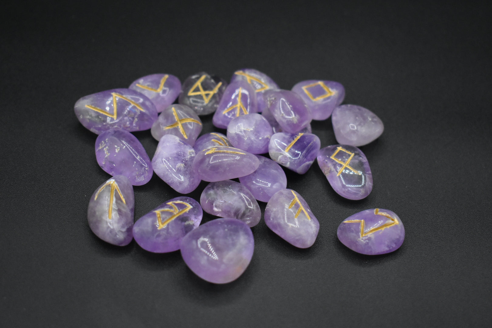 Product photo of amethyst elder futhark runes with gold inlay