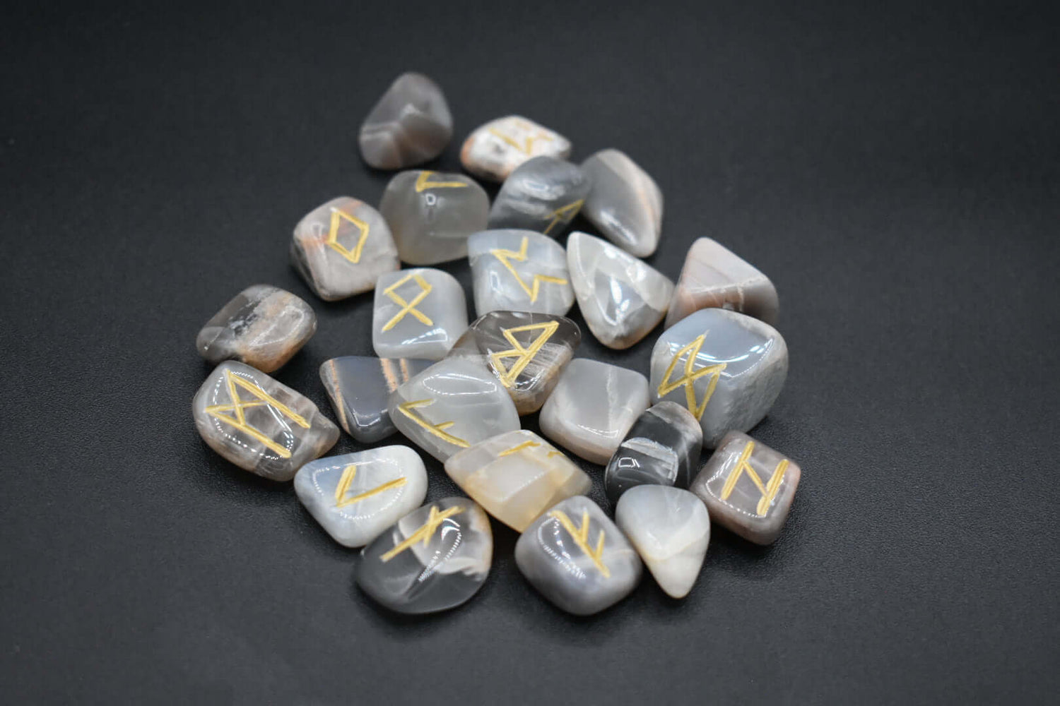 Product photo of dark moonstone elder futhark runes with gold inlay