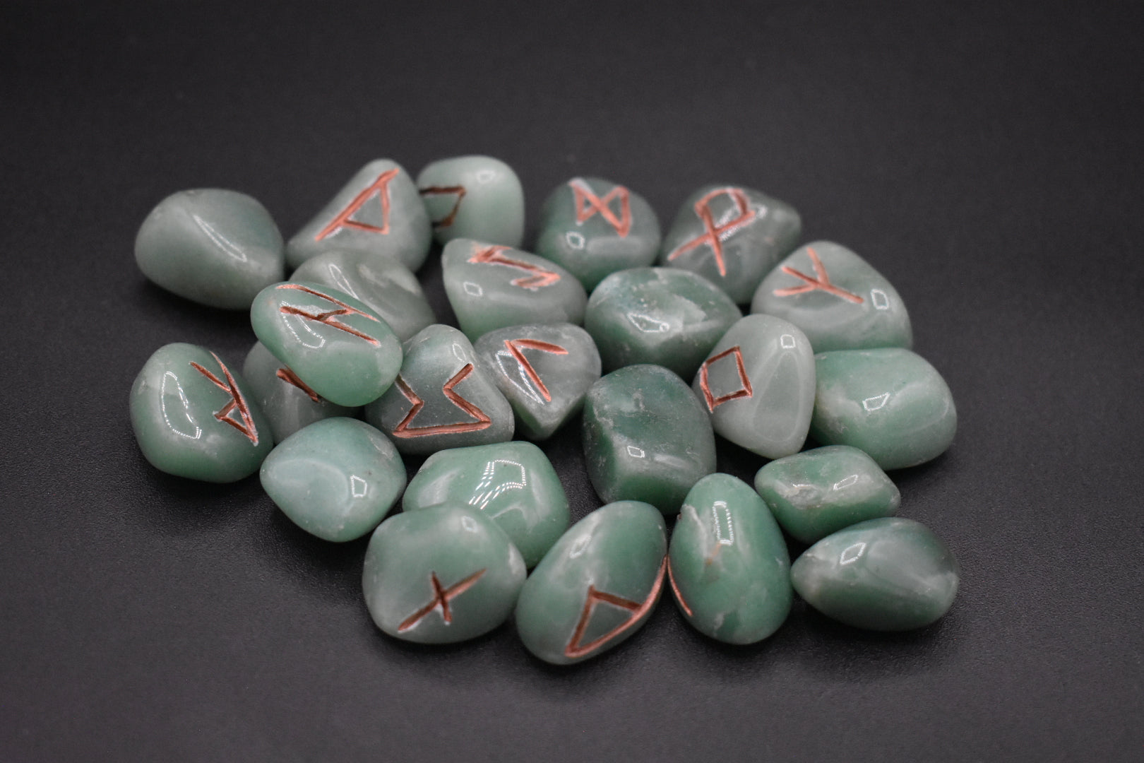 Product photo of green aventurine elder futhark runes with copper inlay