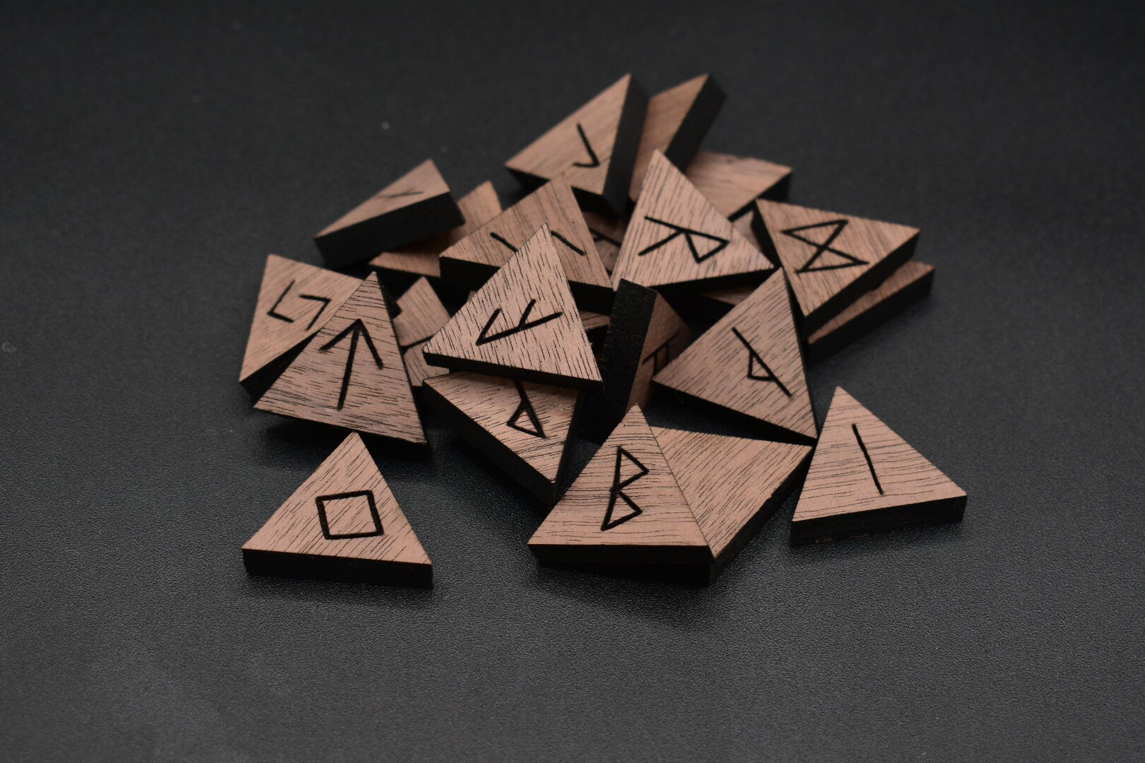 Product photo of laser cut triangle walnut runes