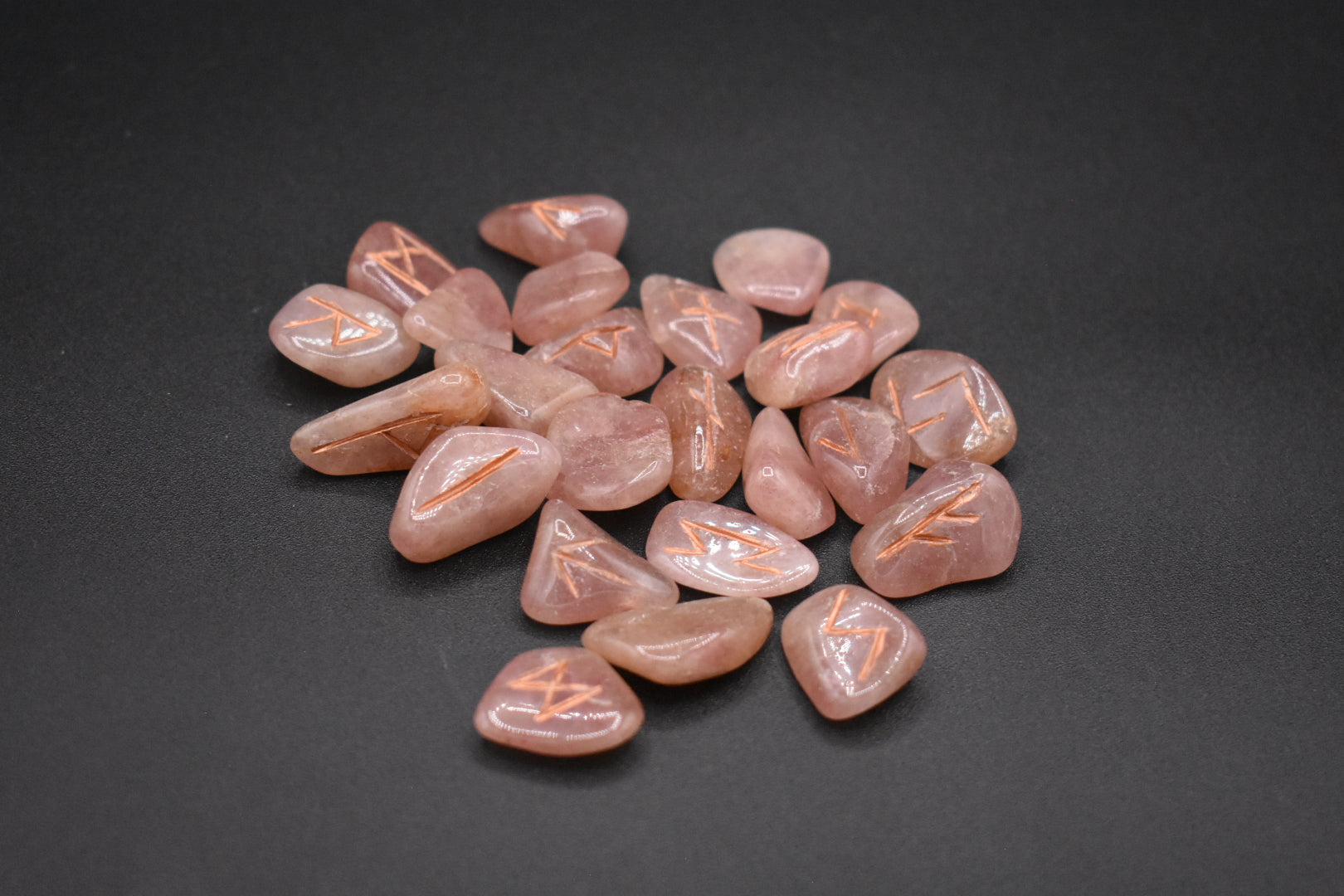 Product photo of red aventurine elder futhark runes with copper inlay