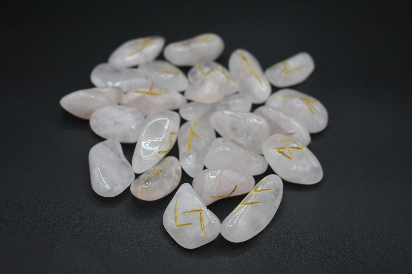 Product photo of rose quartz elder futhark runes with gold inlay