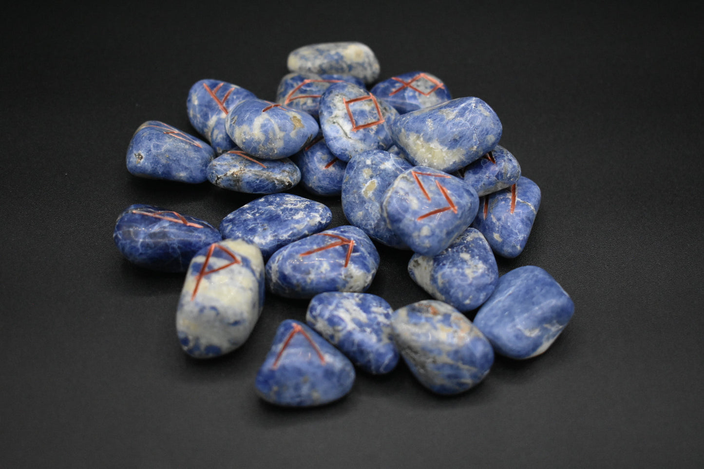 Product photo of sodalite elder futhark runes with copper inlay