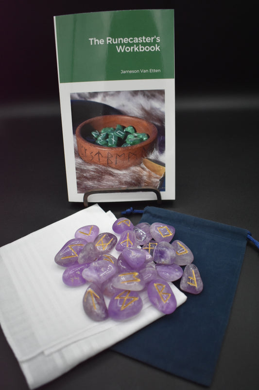 Product photo showing what is included in a full set: the runecaster's workbook, a set of crystal runes, a scatter cloth, and a drawstring bag.